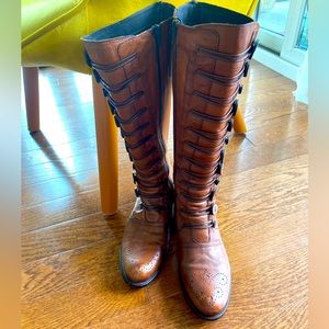 Dune London “buttoned” knee-high leather boots.